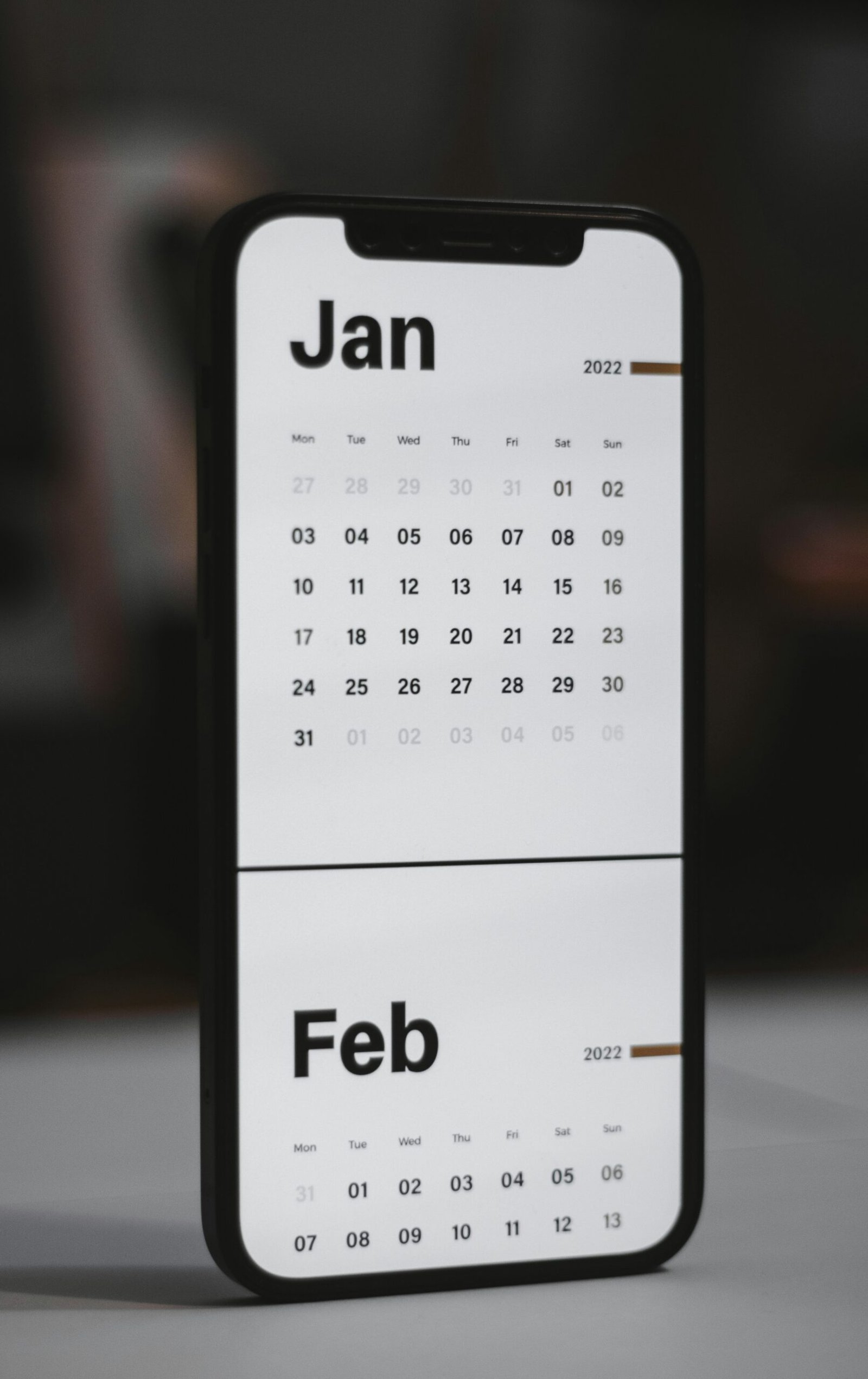 a white and black calendar phone case sitting on top of a table